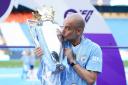 Pep Guardiola kisses the Premier League trophy (Martin Rickett/PA)