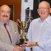 Mike Howe receives the men\'s championship trophy at Shire Park