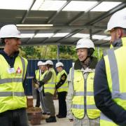 Corey Ratcliff (left), from Stevenage, meets the Princess Royal on a visit to the training hub where he is an apprentice bricklayer.