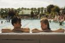 Harry Styles and Emma Corrin in a swimming pool  in movie My Policeman. The scene was filmed at the open-air pool in Hitchin.