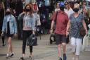 Shoppers may be allowed to ditch the masks from next month. Pictured are shopping in Norwich wearing masks