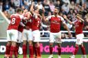 Arsenal's Mesut Ozil (not visible) celebrates scoring his side's second goal of the game with team mates during the Premier League match at St James' Park, Newcastle.