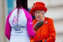 Queen Elizabeth II talks to the first baton bearer, British parasport athlete Kadeena Cox, at the launch of the Queen's Baton Relay for Birmingham 2022.