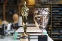 Make-up artist Mark Coulier's Oscar, which he won for 'The Iron Lady', and the BAFTA he won for 'The Grand Budapest Hotel'