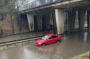 A car gets stuck after heavy rain caused flooding in Martins Way, Stevenage.