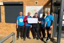 Stevenage Striders present a cheque to Angels charity after their 10k.