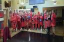 Members wore red dresses to raise money for charity on their 2000th run