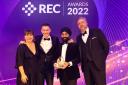 Laurence Johnson (centre left) and Gurmail Singh of Seven Resourcing collect the Best Company to work for (up to 150 employees) award from REC Awards 2022 host Kerry Godliman and Adrian Wightman of award sponsor Severn Trent