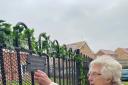 Pamela from Oak Manor placing a lock on the remembrance fence.