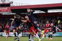 Dan Sweeney battles in the air against two Bradford City defenders
