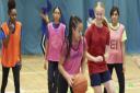 Young people enjoying the opportunity to play basketball.