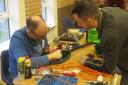 Repairer Andy Moorley looks at a strimmer. The Royston Repair Cafe runs quarterly repair sessions.  (Chris Lee)