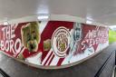 One side of the Stevenage FC-themed underpass features Lucy Webster, captain of the women's team, and mascot Boro Bear.