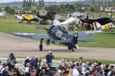Spectators watch as the Grumman F8F Bearcat gets  ready to fly at the Battle of Britain Air Show