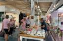 Traders and customers enjoy the charity afternoon tea at Stevenage Indoor Market.