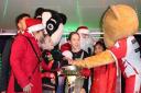 Stevenage mayor Myla Arceno joined Stevenage FC's Boro Bear and the poster competition winner and runners-up to turn on the Christmas lights.