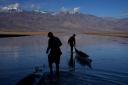 People pull kayaks into the water at Badwater Basin in Death Valley National Park (John Locher/AP)
