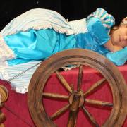 Princess Aurora (Carly Jackson) falls asleep after pricking her finger on the spinning wheel in The Sleeping Beauty.