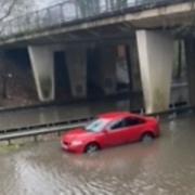 A car gets stuck after heavy rain caused flooding in Martins Way, Stevenage.