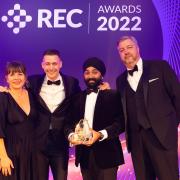 Laurence Johnson (centre left) and Gurmail Singh of Seven Resourcing collect the Best Company to work for (up to 150 employees) award from REC Awards 2022 host Kerry Godliman and Adrian Wightman of award sponsor Severn Trent