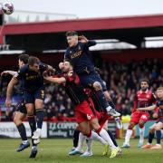 Dan Sweeney battles in the air against two Bradford City defenders