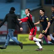 Stevenage have been charged by the FA after a man ran onto the field against Bradford City. Picture: GEORGE TEWKESBURY/PA