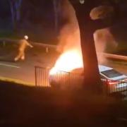 A firefighter races to extinguish a car on fire in Stevenage.