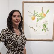 Nina Mayes pictured at the Royal Birmingham Society of Artists next to her painting of the Hitchin Pippin