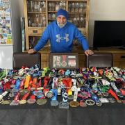 'Arnie the Turbanator' with his collection of marathon medals.