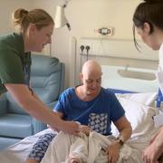 The rehabilitation and wellbeing service help a patient in the inpatient unit.