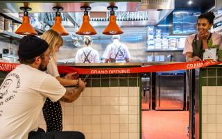 Bread Hospitality founder Tom Ginn and his daughter Huxley cut the ribbon at the grand opening of Toast Kitchen and MILK at Yalm food hall in Norwich