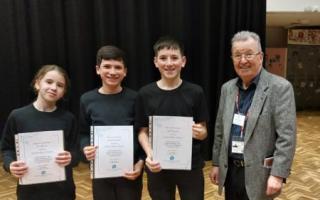 From L to R: Eli, Elliot and Jack with Stephen Gray, a former headteacher who adjudicated at the branch final.