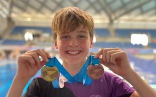 Finn McFarlane with his national medals.