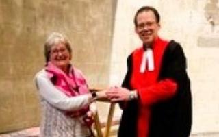 Letchworth embroiderer Jane Pavey received the Coronation Medal from Reverend Robert Latham, sacrist at Westminster Abbey.